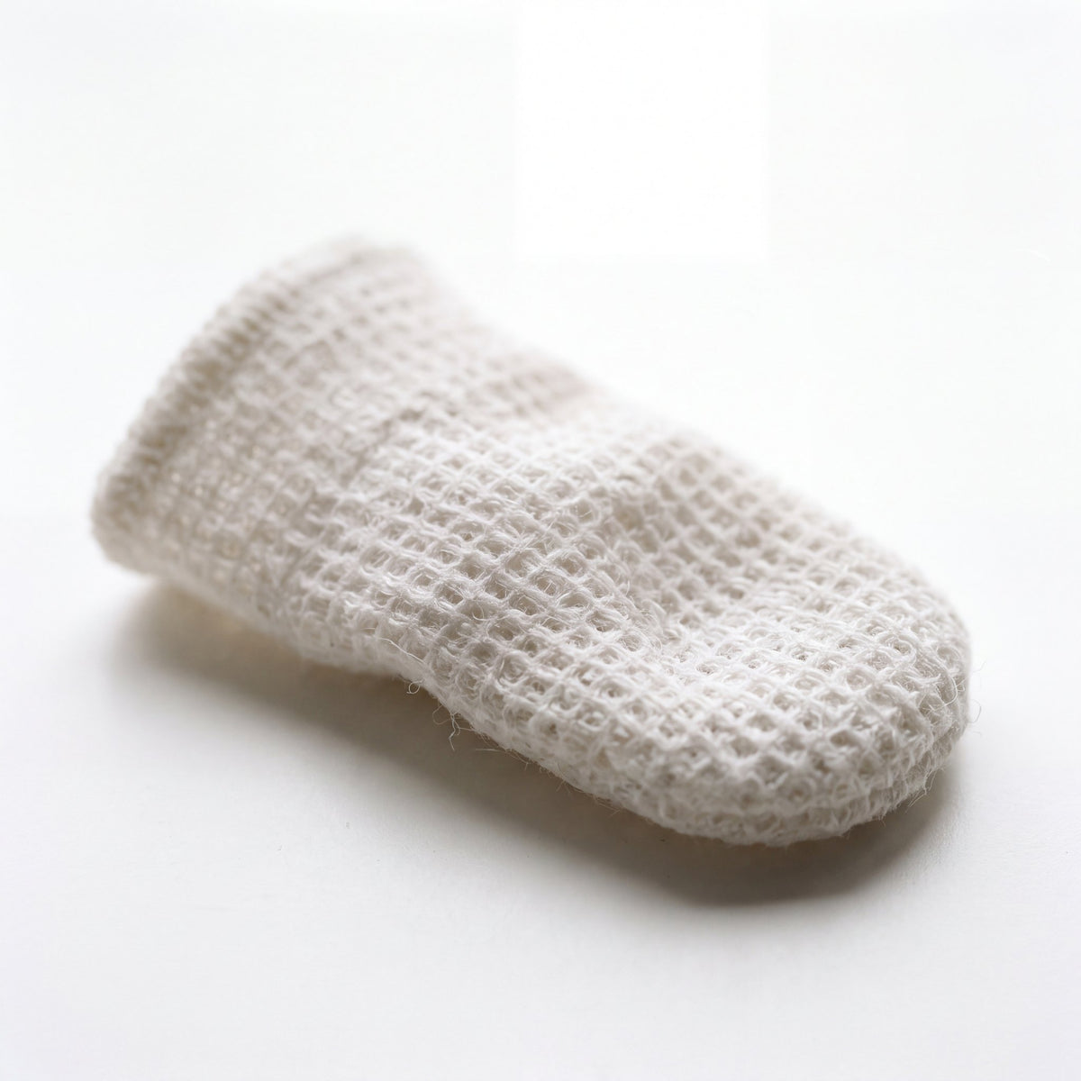 Textured white dental finger wipe sleeve up close