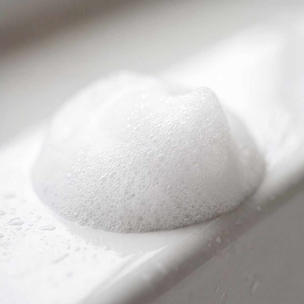 Soft white waterless shampoo foam up close